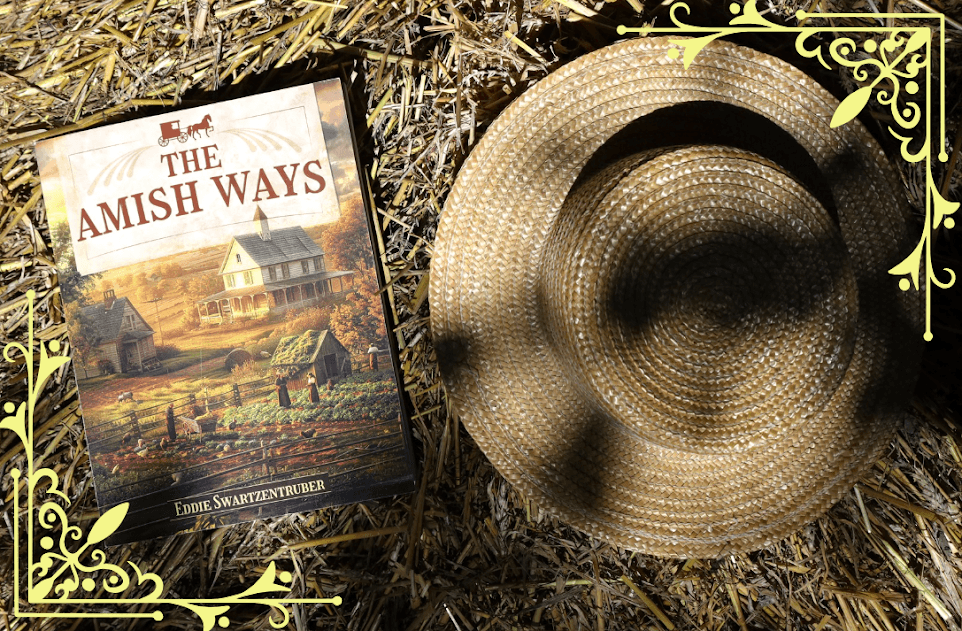 A copy of The Amish Ways book by Eddie Swartzentruber placed on a bed of straw beside a traditional Amish straw hat. The rustic setting highlights the book’s theme of self-sufficiency, survival skills, and Amish traditions.