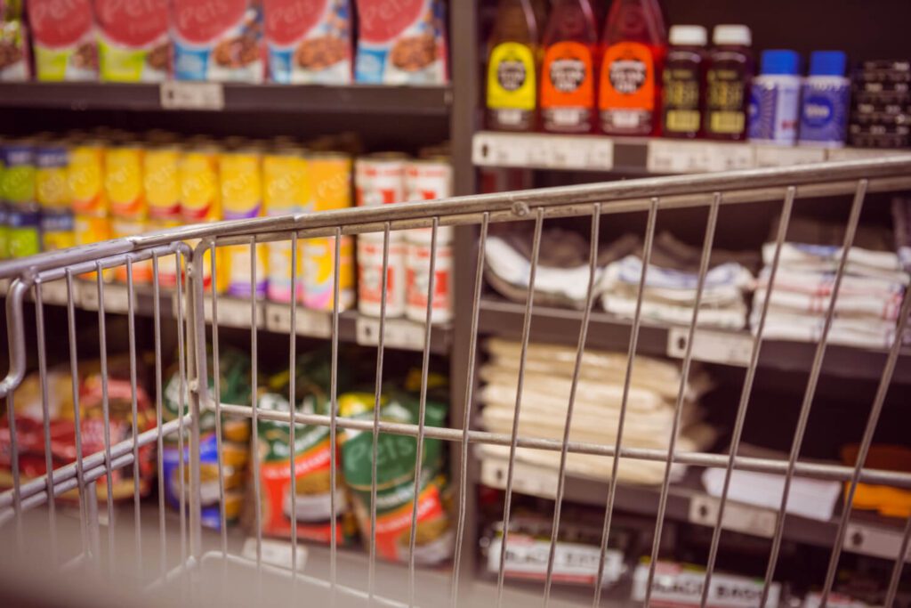 Shopper’s view of grocery store shelves showing limited stock before a food supply chain disruption.