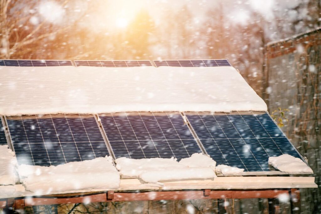Solar panels covered in snow during winter, showing power generation limitations in bad weather