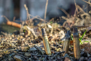 Corroded bullet casings on the ground showing signs of poor ammo storage
