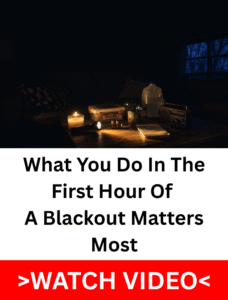 Candle, flashlight, radio, water jug and first aid kit on a table in a dark room during a power outage