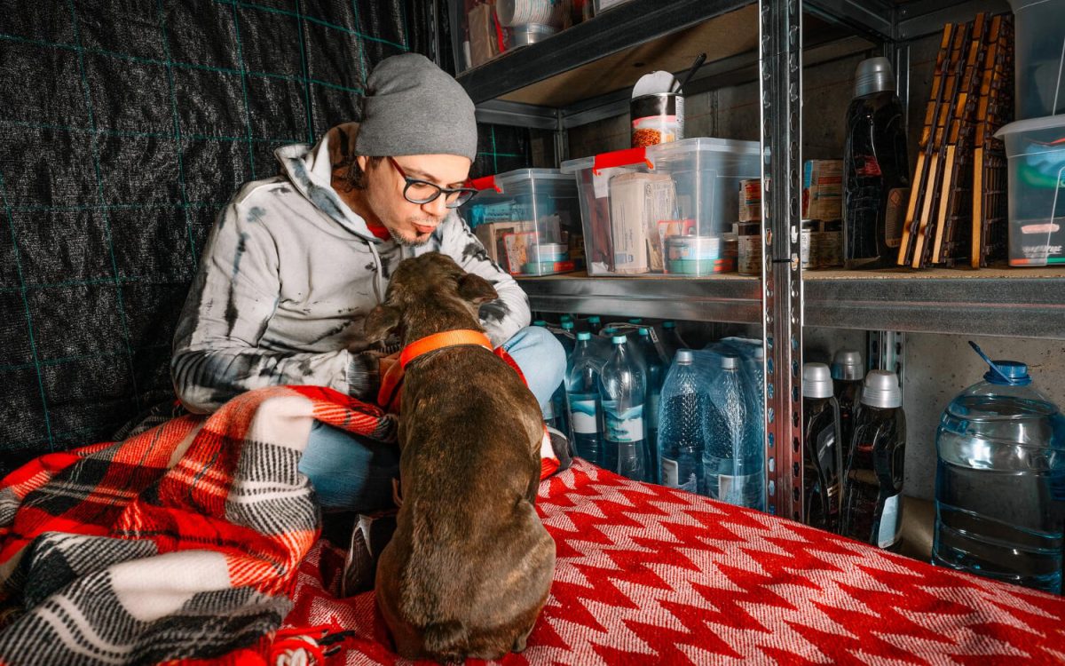 Man prepping with his dog in emergency storage room