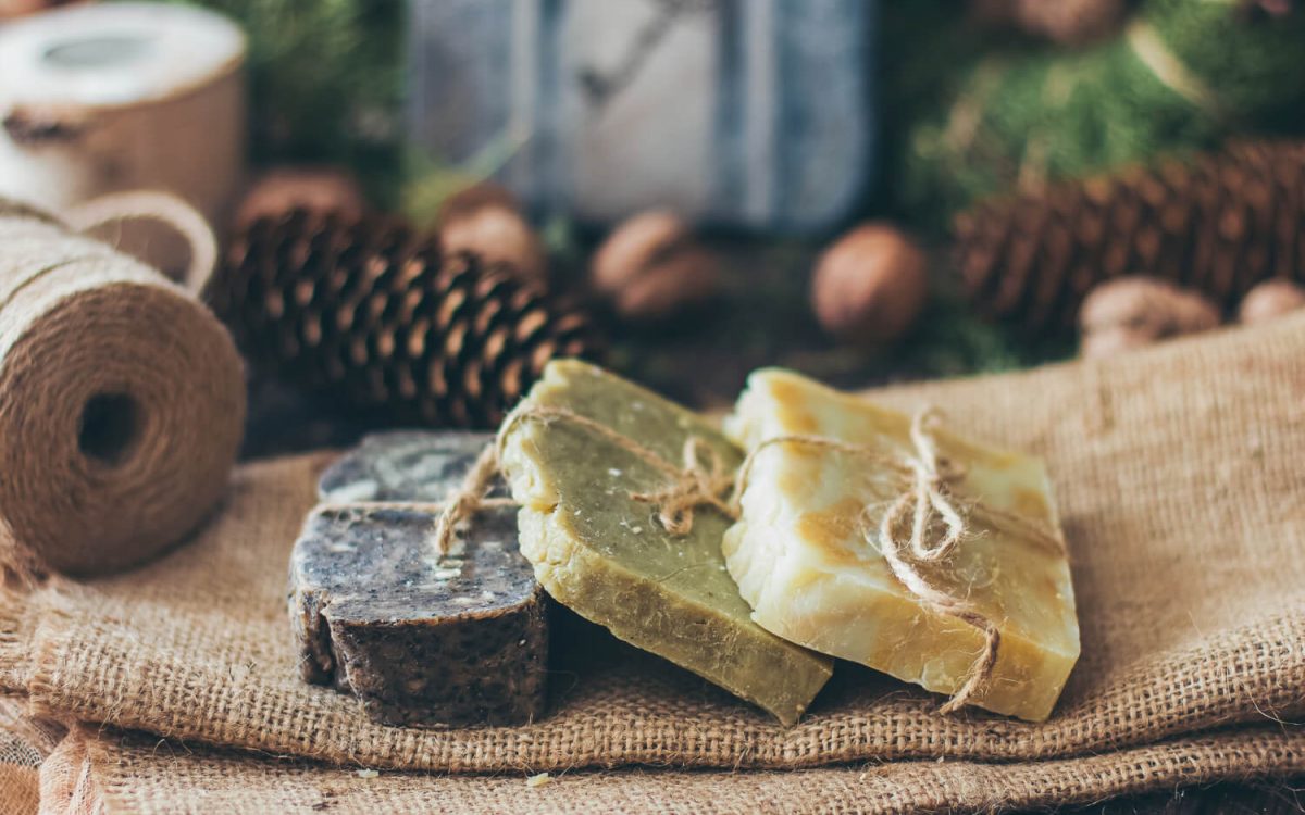Natural mosquito repellent soap bars tied with twine on burlap, rustic prepper setting
