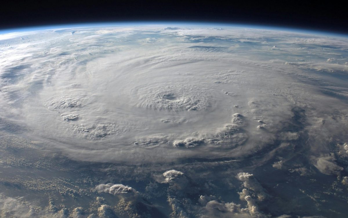 A massive hurricane viewed from space, swirling over the Earth, representing the power and scale of the 2024 hurricane season.